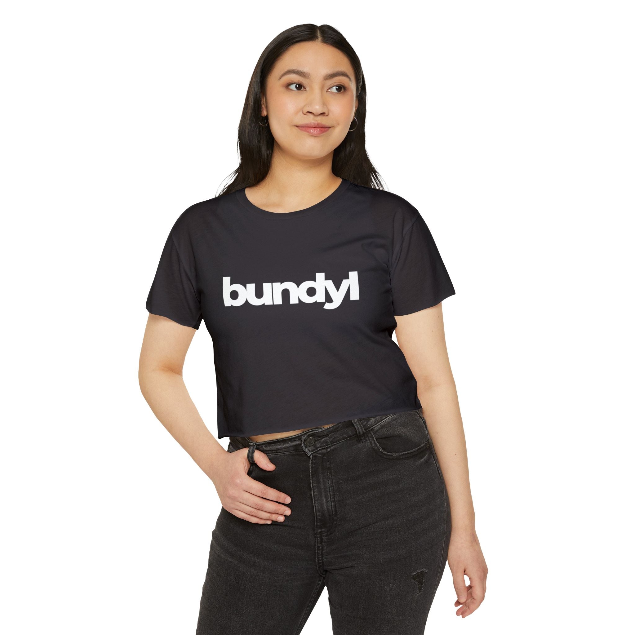 A woman wearing a black crop top with the text 'bundyl' on the front.